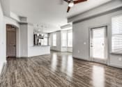 Thumbnail 70 of 128 - A spacious room with wood flooring and a ceiling fan.