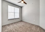 Thumbnail 81 of 128 - A room with a ceiling fan and a window with blinds.