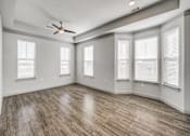 Thumbnail 73 of 128 - A room with wooden flooring and a ceiling fan.