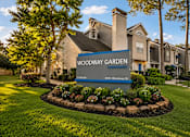 Thumbnail 47 of 52 - A sign for Woodway Garden in front of a building.