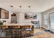 Thumbnail 22 of 34 - Apartments Near Happy Valley For Rent - Sunnyside Village - Clubhouse With Seating Area and Island Table