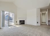 Thumbnail 47 of 51 - a living room with a fireplace and a sliding glass door