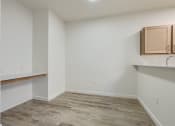 Thumbnail 51 of 51 - an empty room with wood flooring and a kitchen