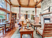 Thumbnail 30 of 51 - One-Bedroom Apartments in Fairview, OR - Lodges at Lake Salish - Clubhouse with Comfortable Seating, Oversized Windows, and a Fireplace