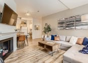 Thumbnail 1 of 51 - Apartments in Fairview-Lodges at Lake Salish-Living Room with Hardwood Style Flooring, a Fireplace, and High Ceilings
