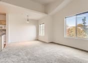 Thumbnail 16 of 51 - Fairview Apartments for Rent - Spacious Living Room with Carpet, Two Large Windows and Dining Area.