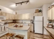 Thumbnail 5 of 51 - Apartments in Fairview for Rent-Lodges at Lake Salish-Kitchen with Appliances, Spotlight Lighting, and Hardwood Style Flooring