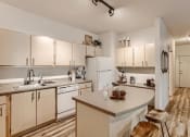 Thumbnail 7 of 51 - Apartments for Rent in Fairview - Fully Equipped Well Lit Kitchen with Wood Flooring and Island.