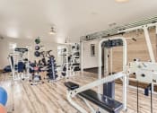 Thumbnail 25 of 51 - Fairview Apartments for Rent-Lodges at Lake Salish-Fitness Center with Equipment, Hardwood Style Flooring, Large Windows, and Overhead Lighting