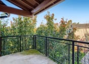 Thumbnail 15 of 51 - Apartments for Rent in Fairview - Lodges at Lake Salish - Large Covered Patio with Metal Railing and Gorgeous Landscape Views