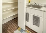 Thumbnail 7 of 13 - A kitchen with white cabinets and a sink.