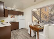 Thumbnail 18 of 20 - A kitchen with brown cabinets and a white refrigerator.