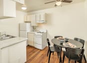 Thumbnail 13 of 22 - A kitchen with a table and chairs.