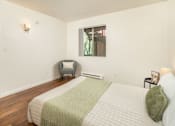 Thumbnail 16 of 22 - A bedroom with a bed, chair, and window.