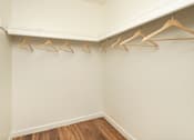 Thumbnail 17 of 22 - A row of wooden hangers are on a white wall.