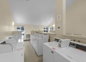 Thumbnail 13 of 13 - A laundry room with washers and dryers.
