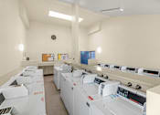Thumbnail 12 of 13 - A laundry room with washers and dryers.
