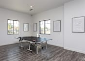 Thumbnail 37 of 45 - A room with a pool table and pictures on the wall.