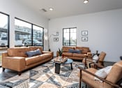 Thumbnail 39 of 45 - A living room with brown leather furniture and a patterned rug.
