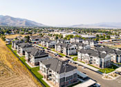 Thumbnail 45 of 45 - A row of houses with a mountain in the background.