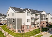 Thumbnail 44 of 45 - A large, modern apartment building with a mix of brick and siding exteriors.