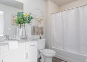 Thumbnail 4 of 45 - A white bathroom with a toilet, sink, and shower.