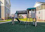 Thumbnail 40 of 45 - A playground structure with a green roof and a slide.