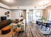 Thumbnail 13 of 45 - A living room with a brown wooden floor and furniture.