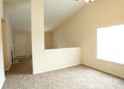 Thumbnail 10 of 10 - A room with a carpeted floor and a window letting in sunlight.