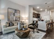 Thumbnail 6 of 35 - Contemporary apartment living room with stylish seating, modern lighting, and seamless flow into the kitchen and dining area.