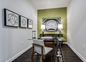 Thumbnail 10 of 35 - Modern home office with desk, ergonomic chair, and natural light from large windows.