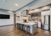 Thumbnail 22 of 26 - A modern kitchen with a large island and stainless steel appliances.