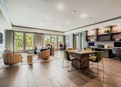 Thumbnail 25 of 26 - A modern living room with a wooden floor and a dining table with chairs.