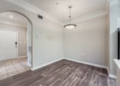 Thumbnail 2 of 32 - A room with a white door and a light brown floor.