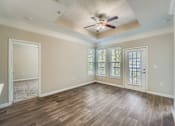 Thumbnail 7 of 32 - A room with wood flooring and a ceiling fan.