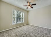 Thumbnail 5 of 32 - A room with a ceiling fan and a window with blinds.