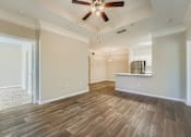 Thumbnail 25 of 32 - A room with a ceiling fan and wooden flooring.