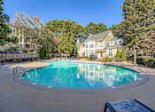 Thumbnail 20 of 32 - A large swimming pool in front of a house.