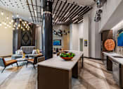 Thumbnail 19 of 35 - Luxury apartment resident lounge with stylish furnishings, natural light, and space for social gatherings.