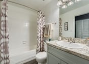 Thumbnail 9 of 37 - A bathroom with a toilet, sink, and shower.