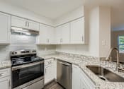 Thumbnail 16 of 37 - A kitchen with a stove, dishwasher, and sink.