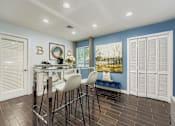 Thumbnail 36 of 37 - A dining area with a glass table and white chairs.