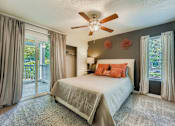 Thumbnail 5 of 37 - Bedroom with a bed, a ceiling fan, and a sliding glass door.