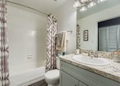 Thumbnail 14 of 37 - A bathroom with a toilet, sink, and shower.