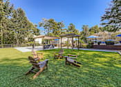 Thumbnail 26 of 37 - A backyard with a wooden bench and a gazebo.