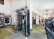 Thumbnail 27 of 35 - Modern fitness center with cardio machines, strength training equipment, and free weights.