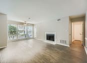 Thumbnail 39 of 39 - A spacious living room with a fireplace and sliding glass doors.