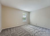 Thumbnail 37 of 39 - A room with a carpeted floor and a window.