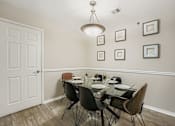 Thumbnail 4 of 39 - A dining room with a glass table and chairs.