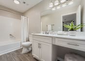 Thumbnail 6 of 39 - A white bathroom with a toilet, sink, and bathtub.